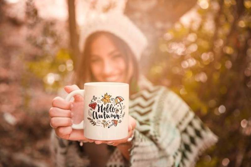 Autumn concept with woman holding mug