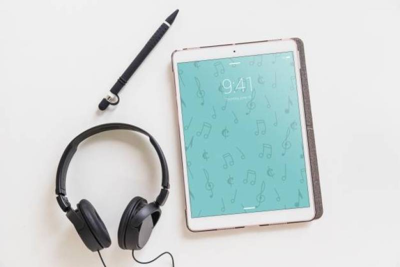 Music mockup with headphones next to tablet