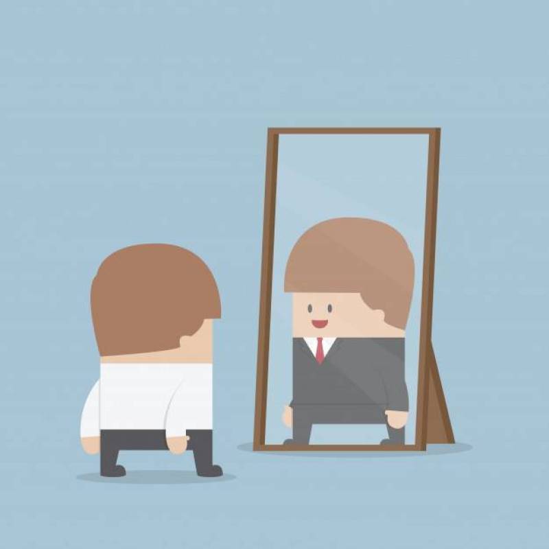 Businessman see his successful future in the mirror
