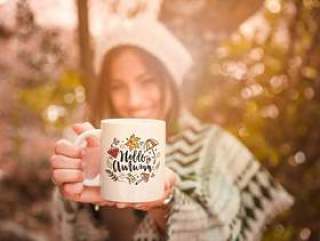 Autumn concept with woman holding mug