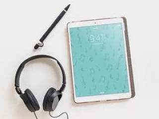 Music mockup with headphones next to tablet