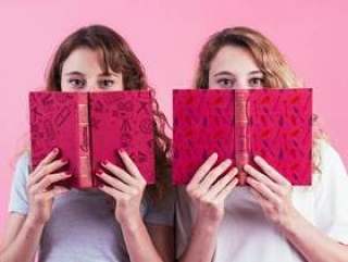 Young girls holding book cover mockup